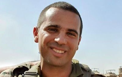 Lt. Col. Tomer Grinberg embraces his daughter, Arbel, in July 2023. (IDF Spokesperson)