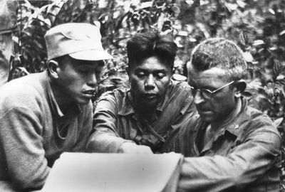 BG Frank D. Merrill (right), Commander, 5307th Composite Unit (Provisional), talks with Kachin Scouts.